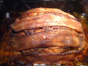 Baked meatloaf topped with bacon strips - Yum!