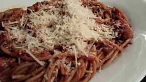 Whole Wheat Spaghetti Tossed with Meat Sauce and Topped with Parmesan (Photo Credit: Adroit Ideals)