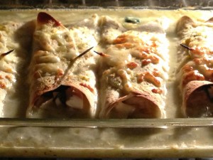 Chicken and Spinach Enchiladas with Green Chile Sauce baking in the oven (Photo Credit: Adroit Ideals)