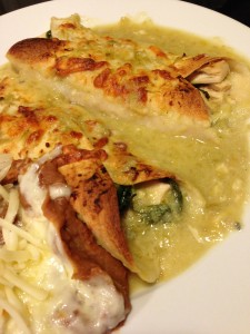 Chicken and Spinach Enchiladas with Green Chile Sauce served with Refried Beans (Photo Credit: Adroit Ideals)