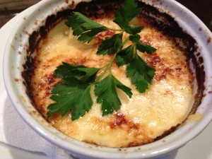 Baked Potatoes au Gratin with golden potatoes, Swiss and Parmesan cheeses, garlic, and cream (Photo Credit: Adroit Ideals)