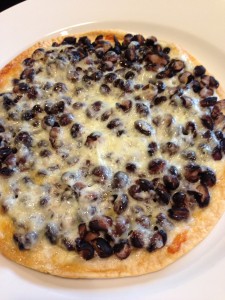In the oven, melt some Monterey Jack cheese along with some black beans on a tortilla for my TexMex Tortilla Pizza! (Photo Credit: Adroit Ideals)