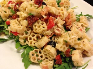 Arugula over Pizza Pasta Salad is a family-friendly meal! (Photo Credit: Adroit Ideals)