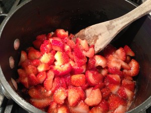 Stir the strawberries, sugar, and lemon juice until the sugar dissolves (Photo Credit: Adroit Ideals)