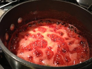 The sugar has dissolved into a syrup around the strawberries so keep stirring (Photo Credit: Adroit Ideals)