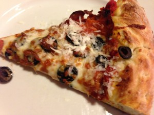 A slice of pepperoni, black olive, and mozzarella pizza!  (Photo Credit: Adroit Ideals)