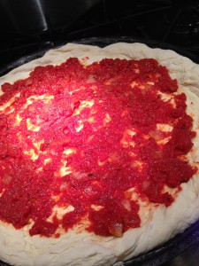 Roasted Tomato Sauce spread on pizza dough  (Photo Credit: Adroit Ideals)