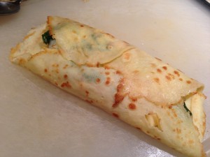 Rolled filled smoked chicken crepe with spinach and shallots (Photo Credit: Adroit Ideals)