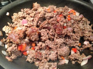 Saute the ground beef, onions, red bell pepper in some oil. (Photo Credit: Adroit Ideals)