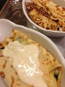 Spoon the white sauce over the smoked chicken crepes (Photo Credit: Adroit Ideals)