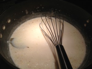 White sauce simmers along with minced onion, a bay leaf and paprika for flavor (Photo Credit: Adroit Ideals)