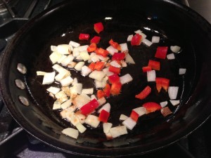Saute the onions and red bell pepper in the olive oil (Photo Credit: Adroit Ideals)