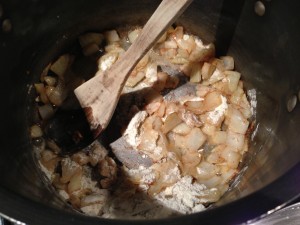 Stir the flour into the sauteed onions (Photo Credit: Adroit Ideals)