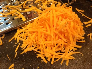 Shred the sharp cheddar cheese (Photo Credit: Adroit Ideals)