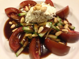 Super easy tomato and cucumber salad. Top with tarragon balsamic dressing, peppered goat cheese, and toasted pine nuts! (Photo Credit: Adroit Ideals)