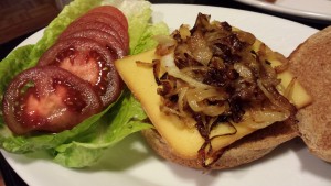 A buffalo burger with smoked gouda cheese, grilled onions, lettuce and tomato (Photo Credit: Adroit Ideals)
