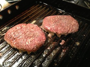 Buffalo burgers searing in a grill pan on the stove (Photo Credit: Adroit Ideals)