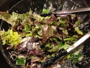 Caesar dressing on torn red and green leaf lettuce -- you don't have to use Romaine lettuce!  (Photo Credit: Adroit Ideals)