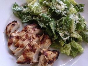 Caesar salad accompanies a warm grilled chicken breast (Photo Credit: Adroit Ideals)