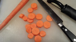 Peel and then slice some carrots into coins (Photo Credit: Adroit Ideals)