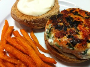 Sockeye Salmon Burger with Spinach and Feta.  Served on a toasted wheat bun with garlic aioli.  Sweet Potato fries on the side.  (Photo Credit: Adroit Ideals)