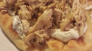Place the pulled chicken on the tzatziki dressing (Photo Credit: Adroit Ideals)