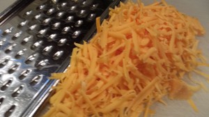 Shredded sharp cheddar cheese adds a tang to any dish!  (Photo Credit: Adroit Ideals)