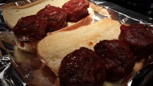 Spoon meatballs and some sauce onto toasted sandwich rolls (Photo Credit: Adroit Ideals)
