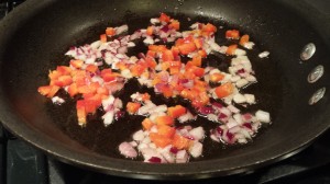 Saute the diced onions and red bell pepper in some olive oil.  (Photo Credit: Adroit Ideals)
