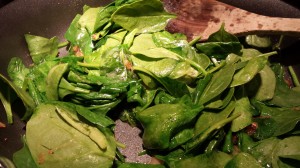 Stir the spinach and cook until it wilts slightly (Photo Credit: Adroit Ideals)