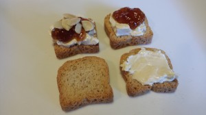 Four Steps: Mini-toast, spread mini-toast with Laughing Cow cheese, add fig jam, top with toasted sliced almonds (Photo Credit: Adroit Ideals)