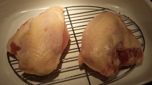Two bone-in skin-on chicken breasts (Photo Credit: Adroit Ideals)