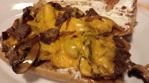Gooey yellow American Cheese tops the steak (Photo Credit: Adroit Ideals)