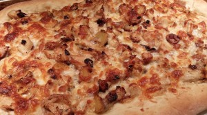 Pizza topped with Chicken, Roasted Garlic, Fingerling Potatoes and Parmesan and Mozzarella cheeses (Photo Credit: Adroit Ideals)