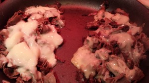 Melt the cheeses on top of the beef onion mushroom mixture (Photo Credit: Adroit Ideals)