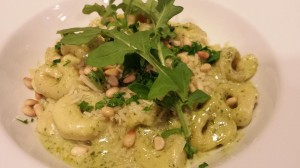 Basil Arugula Pesto tossed with Cheese Tortellini topped with shredded parmesan, toasted pine nuts, chopped basil and fresh whole arugula leaves (Photo Credit: Adroit Ideals)