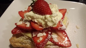 Strawberry Almond Tart garnished with whipped cream and a whole strawberry! (Photo Credit: Adroit Ideals)