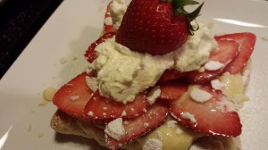 Dessert: Strawberries and almond pastry cream on a baked puff pastry shell topped with whipped cream and toasted sliced almonds. (Photo Credit: Adroit Ideals)