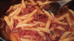 Add the cooked penne to the sauce and toss. (Photo Credit: Adroit Ideals)