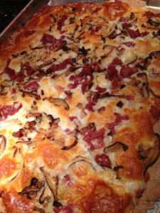 Cremini mushrooms and crispy sauteed prosciutto top a cheesy pizza (Photo Credit: Adroit Ideals)