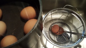 Use a slotted spoon to remove the eggs to a colander (Photo Credit: Adroit Ideals)