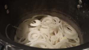 Put the sliced onions in a soup pot with some melted butter and olive oil (Photo Credit: Adroit Ideals)