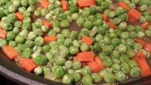 Add the peas to the carrots and onions (Photo Credit: Adroit Ideals)