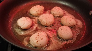Sear the scallops in butter on each side until browned (Photo Credit: Adroit Ideals)