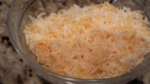 Shredded cheese to top the Shepherd's Pie (Photo Credit: Adroit Ideals)
