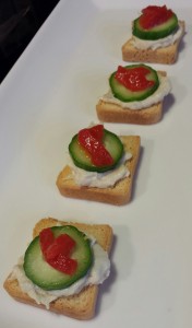 Smoked White Fish Salad Mini Toasts with a Mini Cucumber Slice and Sliver of Roasted Red Bell Pepper (Photo Credit: Adroit Ideals)