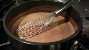 Whisk the hot chocolate until the chocolate bar pieces melt (Photo Credit: Adroit Ideals)