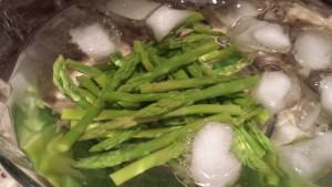Blanch the asparagus spears and then plunge them into ice water to retain a bright green color (Photo Credit: Adroit Ideals)