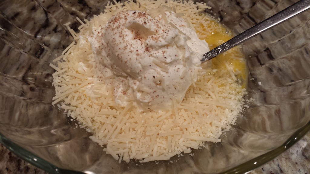 Mix the ricotta, grated nutmeg, and shredded parmesan into the beaten egg  (Photo Credit: Adroit Ideals)