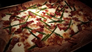 Fresh from the Oven: Pizza with Crispy Prosciutto, Fresh Asparagus, and Creamy Ricotta (Photo Credit: Adroit Ideals)